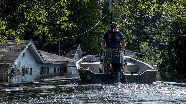 cajun navy responder in a boat in floodwater