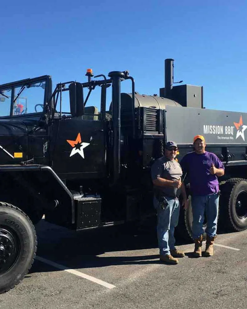 cajun navy pinnacle search and rescue personnel in front of a deuce and a half